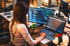 Esther Wambui working on a laptop